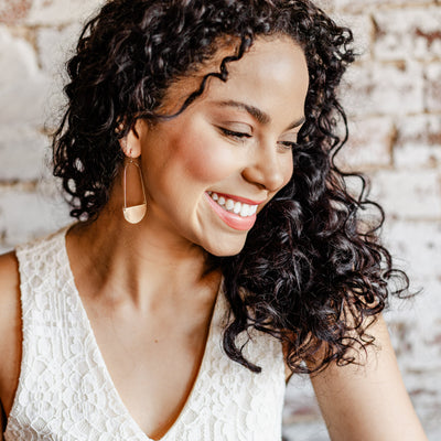 THE SOPHIE HALF MOON BRUSHED EARRINGS IN GOLD featured on a model.