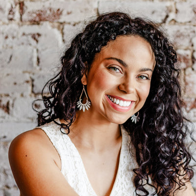 Model wearing the Matte White Leaf Dangle Earrings