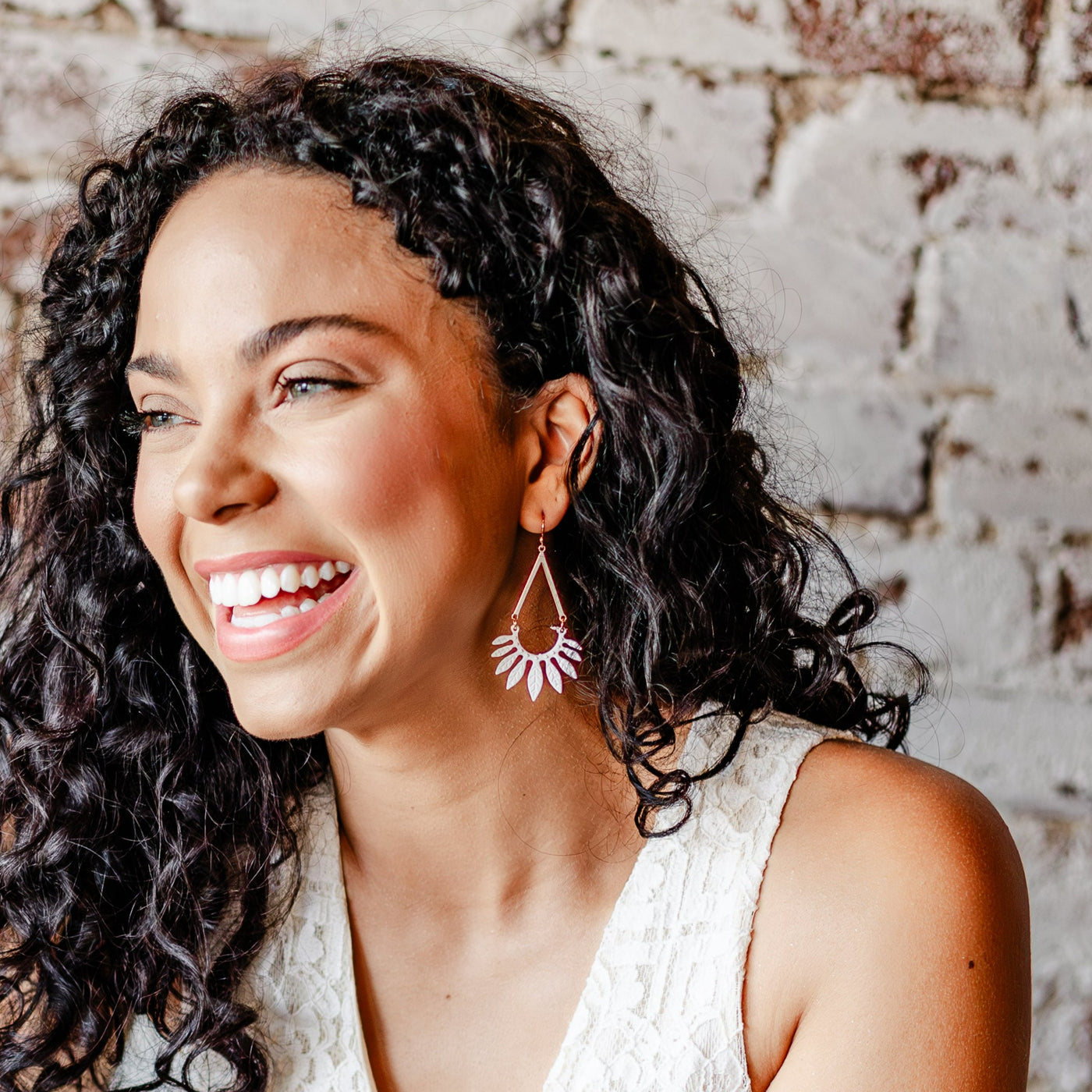 Model wearing the Matte White Leaf Dangle Earrings
