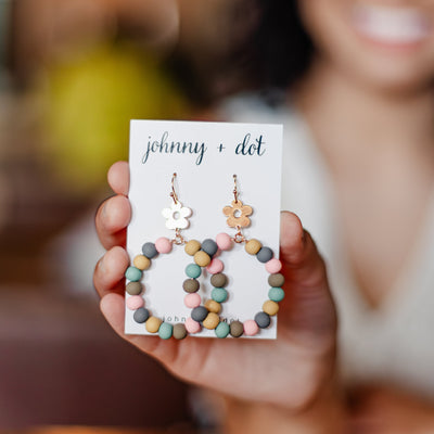 Model holding our Round Clay Ball Drop Earrings