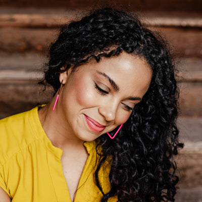 Gold Rosalie Geometric Hoops with Bright Pink Matte Coating on model. 