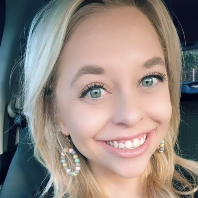 Elsie Earrings shown on a happy customer. 
