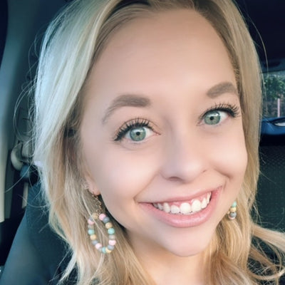 Elsie Earrings shown on a happy customer. 
