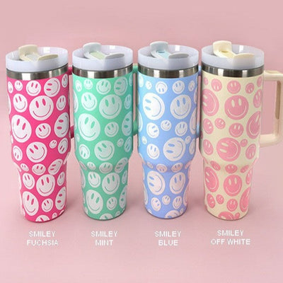 Four smiley face 40 oz tumblers with cute happy faces all over. Availbale in fuschia, mint, blue, and off white. 
