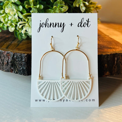 Our Iris Earrings feature an oval-shaped base with semi-circle sunbeams.  Pictured on Johnny & Dot Earring Card.