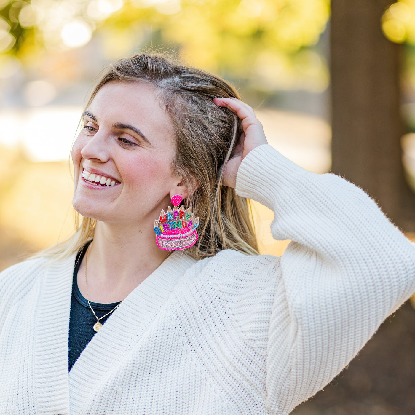Model wearing large Happy Birthday Earrings for a student's birthday!