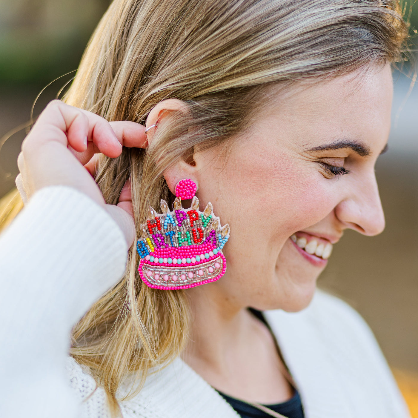 Model wearing large Happy Birthday Earrings for a student's birthday!